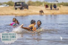 Kids playing in the flowing Colorado River at Vado Carranza in the Mexicali Valley. July 2021.