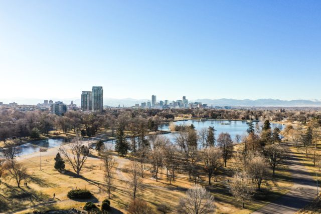 City Park in Denver, Colorado with ponds and city buildings in the distance